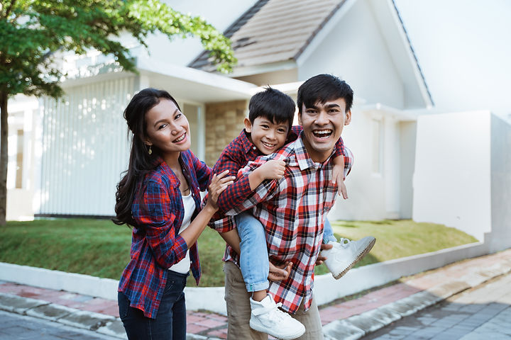 asian-family-standing-front-their-new-house-together.jpg