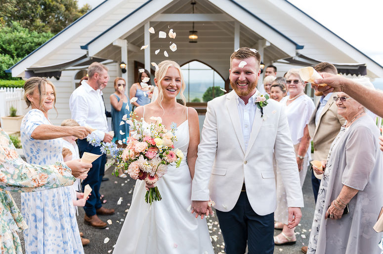 Couple are showered with rose petal confetti after their wedding ceremony at Tiffanys Maleny Queensland Australia