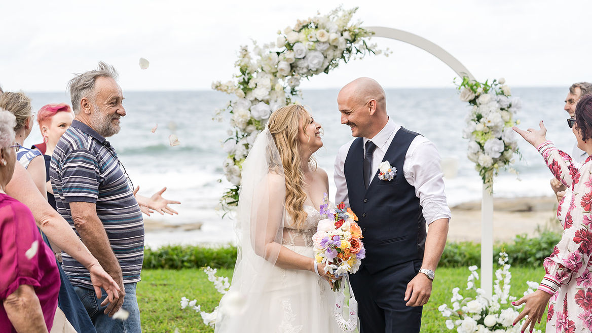 Beautiful Wedding Arch with White Flowers at the beach
