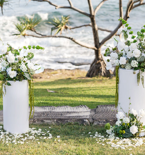 Classic Wedding Ceremony decoration Hire Sunshine Coast with ocean in the background and rose petals