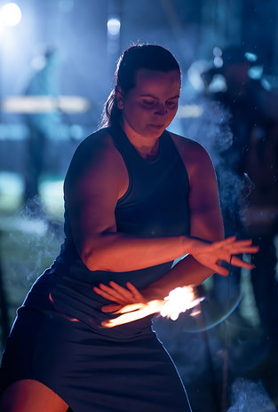 Bailee performing fire leviwand at AUM festival.