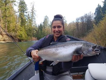 Smiling angler holding a fresh Coho Salmon caught during the legendary fall Coho run on the Cowichan River