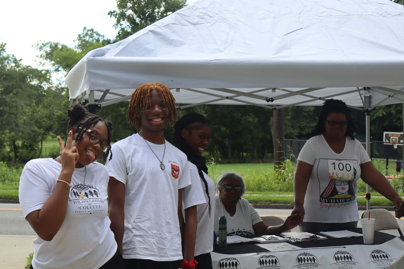 Volunteers smiling to have their picture taking and the purpose walk event.