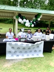 Volunteers posing for a picture at the sign-table.