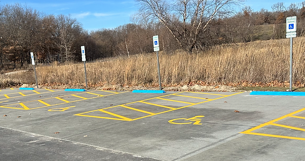 Handicap parking pavement markings, signage and parking blocks in a parking lot in Linn County, Iowa