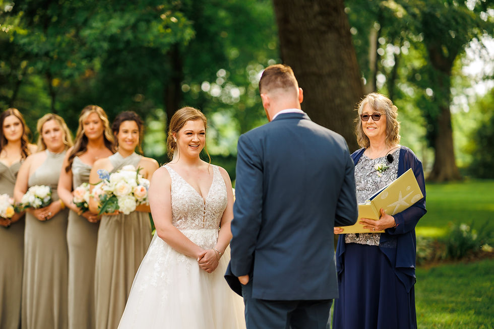 The bride reacts to the groom's vows during the ceremony.