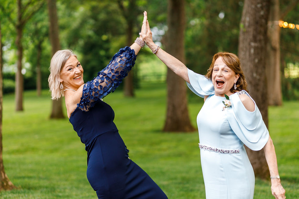 The mothers of the bride and groom high five.
