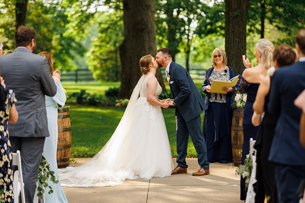 The bride and groom kiss during the ceremony.