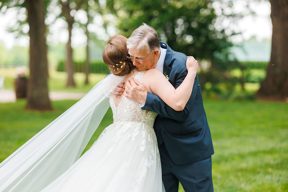 The bride hugs her dad after their First Look.