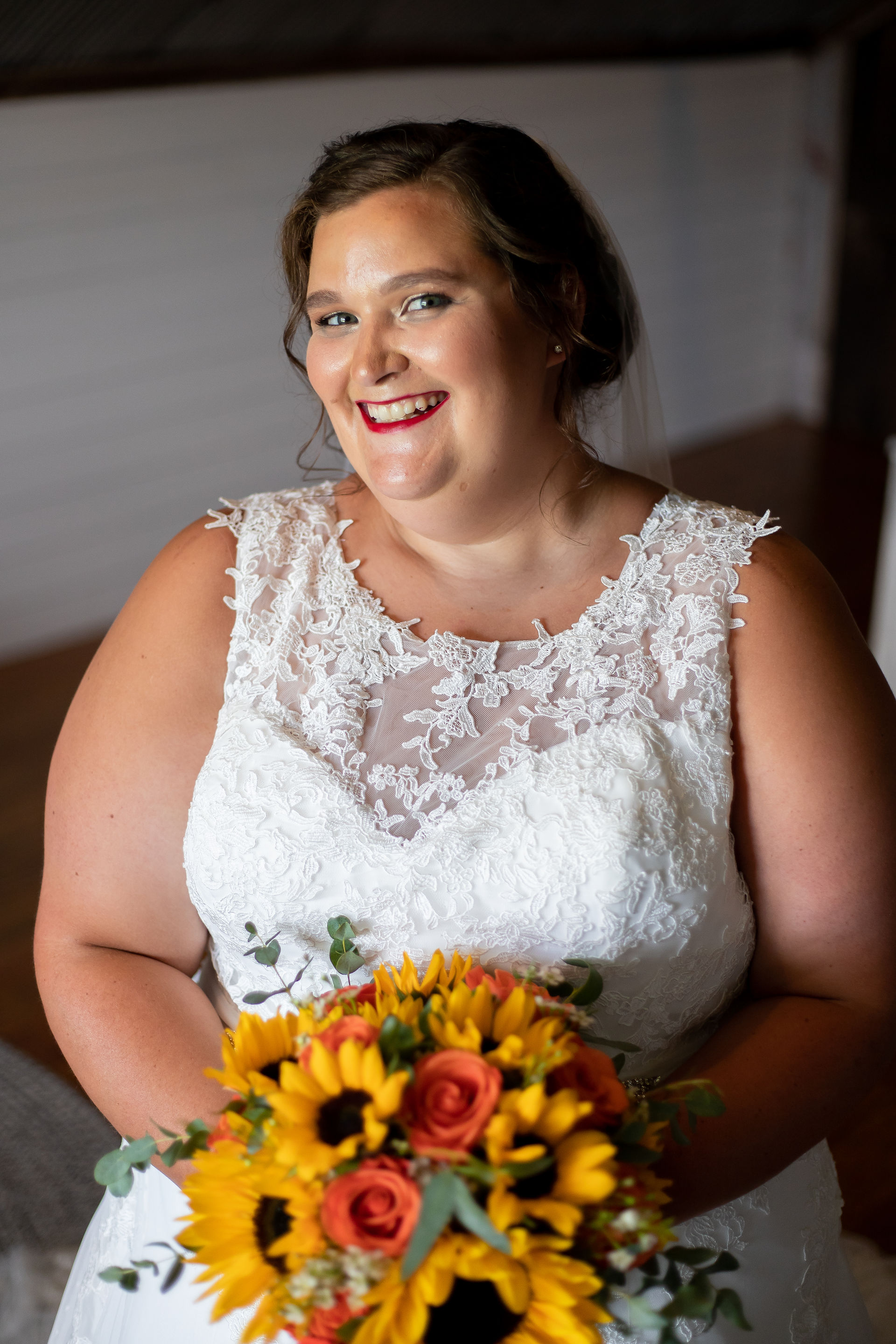 Bridal portraits, lace dress, sunflower bouquet.