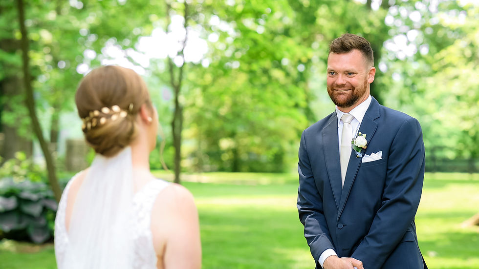 The groom reacts the seeing his bride during their First Look.