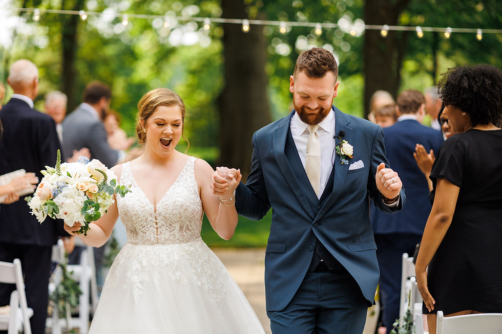 The bride and groom celebrate as they walk down the aisle after saying "I do".