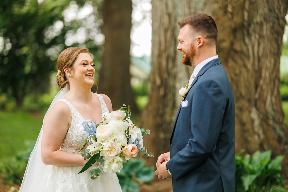 The bride and groom smile at each other during their First Look.