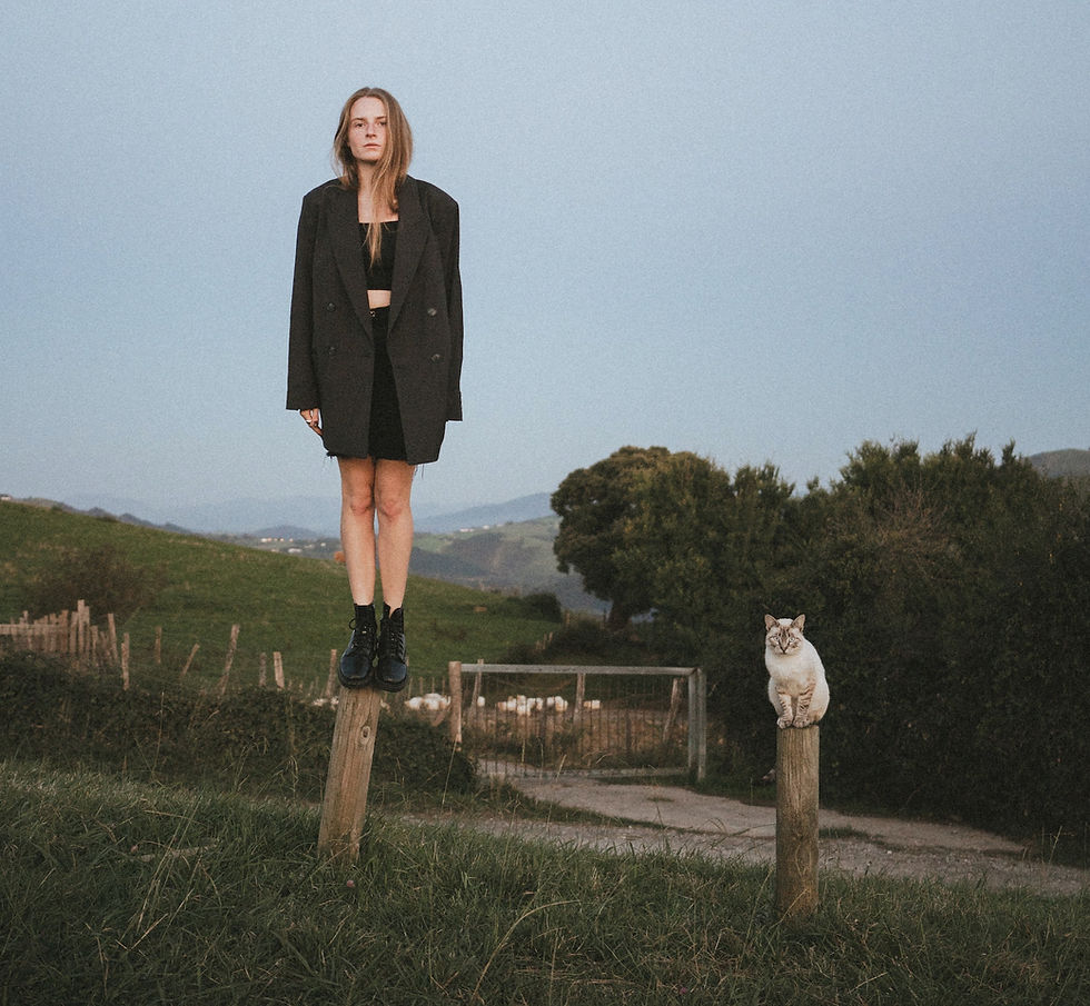 Clearly a woman and cat on stakes