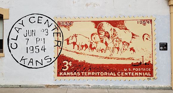Featuring bending wheat fields and a covered wagon train, this postage stamp was issued to mark the 100-year anniversary of the Kansas Territory.