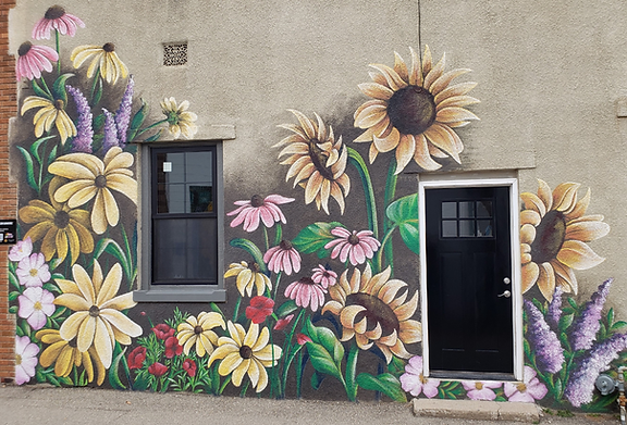 An inviting arrangement of delicate native flora in full bloom - purple coneflower, jerusalem artichoke, plains sunflower, showy evening primrose, false indigo and scarlet globe mallow.