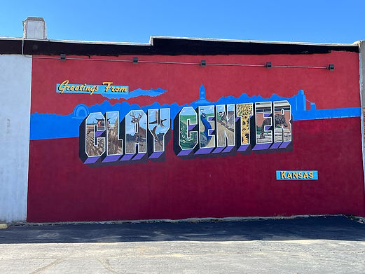 Featuring area attractions and scenes of Clay County, rural life is celebrated in this postcard style mural. Several Clay Center hidden gems can also be found in this mural by those familiar with the area.