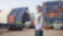Smiling Person Standing In Front Of Container Yard_edited.jpg