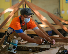 handyman working with table saw