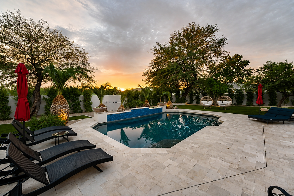 Santa Barbara inspired backyard at 27686 N 65th Way with covered patio, outdoor fireplace, built-in BBQ, pool, and hot tub