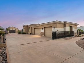 Front elevation of 5643 E Rancho Tierra Drive, a 1.2 acre Cave Creek luxury estate with rotunda entry courtyard and desert landscaping