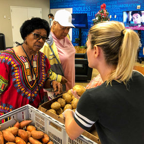Moorland Family YMCA at Oak Cliff (December 14, 2021A). A lovely customer asking Dr. Varga about our jicamas.