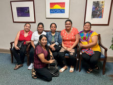 DPS family members sits on couch