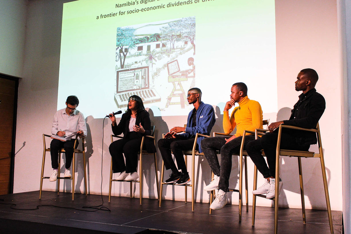 People engaging in a discussion at The Village Opera House.