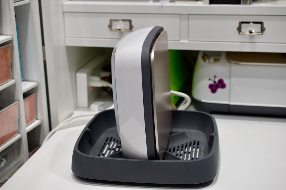 Cricut Easy Press sitting on it's side in it's holder, be careful, it's very hot!