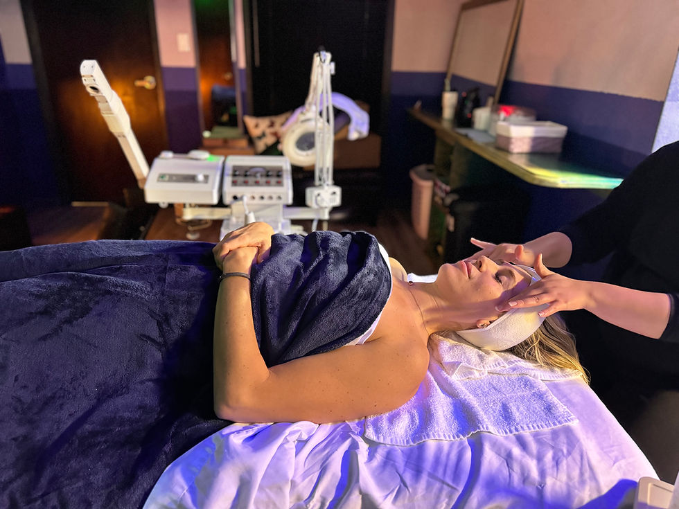 Client in Olysis Dallas Spa facial room getting facial treatment massage.