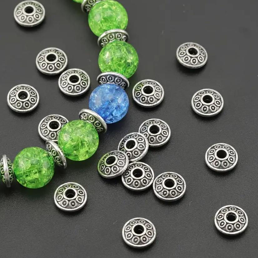 Decorative charms and spacer beads paired with colorful glass beads.