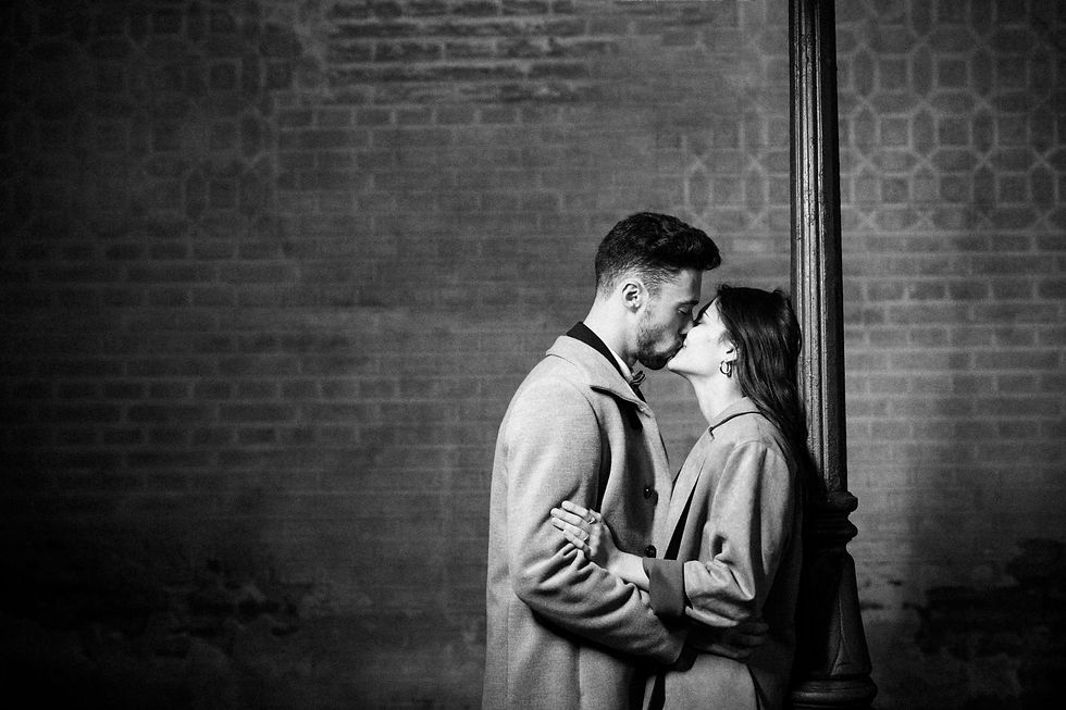 young-man-kissing-hugging-woman-near-street-lamp.jpg