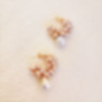 Blush Pearl Garden earrings on soft ivory textured background