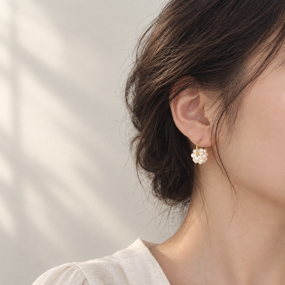 Model wearing Orb pearl cluster hoop earring, side profile
