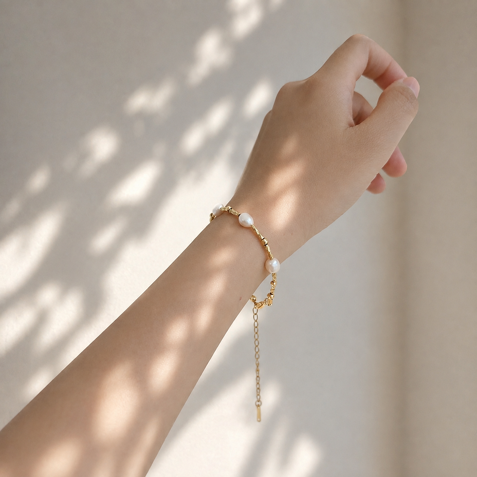 Tratto freshwater pearl bracelet worn on wrist, titanium steel extender chain visible