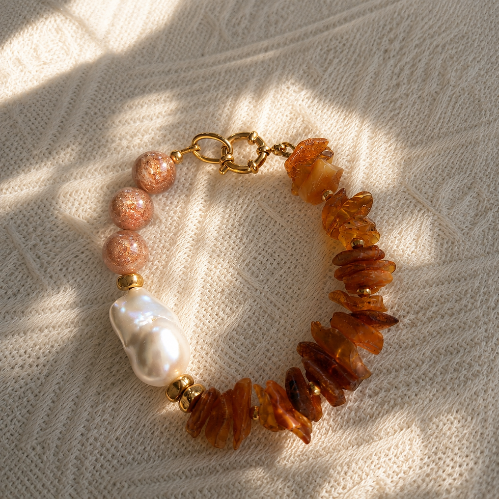 Raw amber bracelet with sunstone and baroque freshwater pearl on cream knit fabric