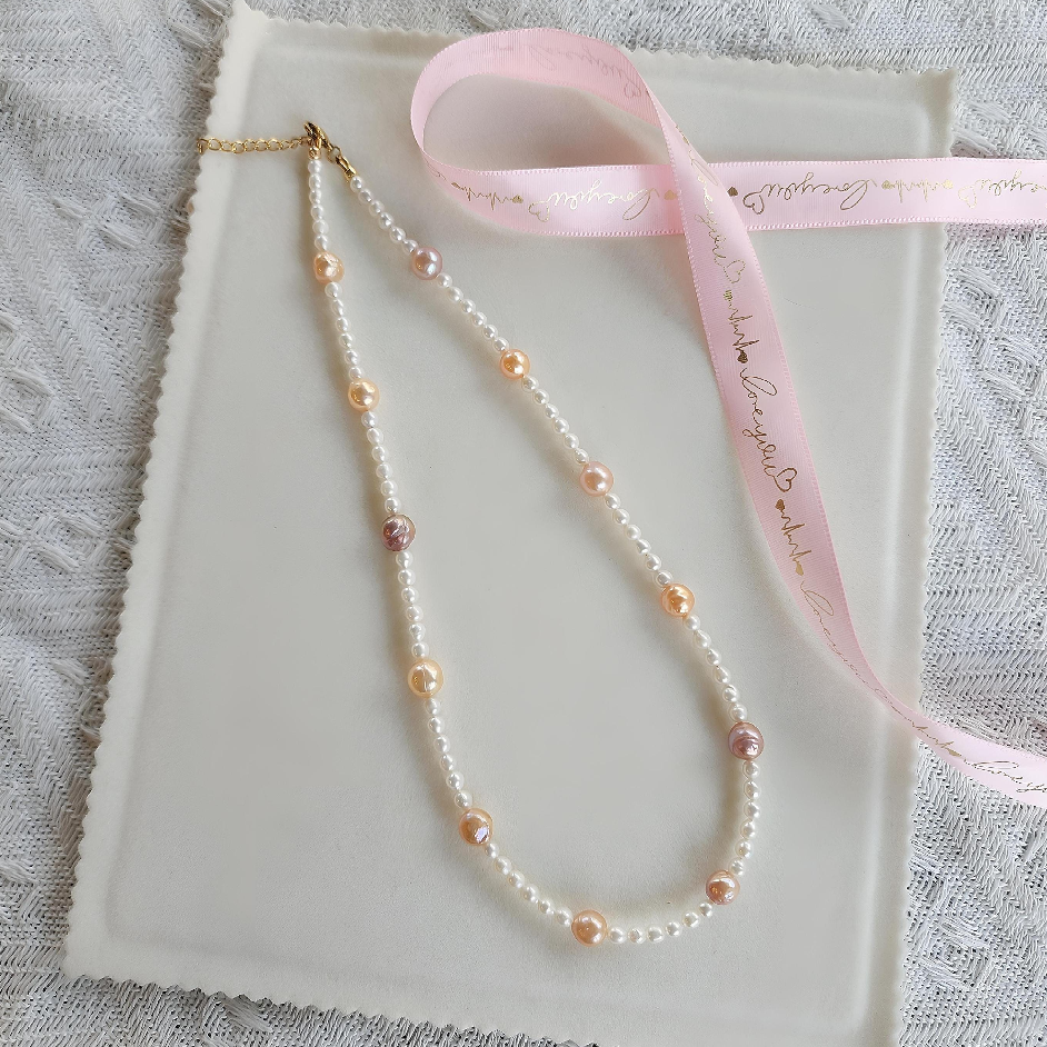 Multicolor freshwater pearl necklace with peach and lilac pearls, gift wrapped with pink ribbon