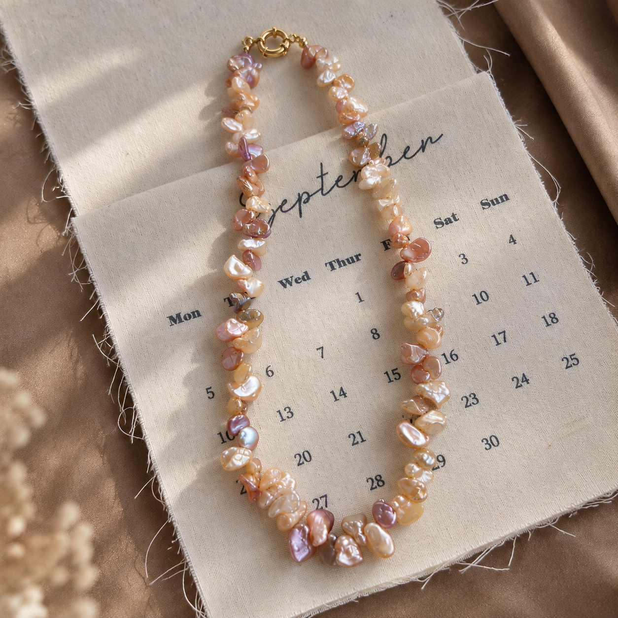 Mosaic keshi pearl necklace on calendar fabric background
