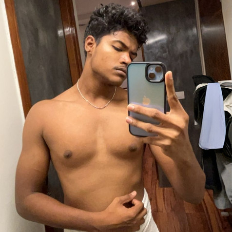 Shirtless young man taking mirror selfie