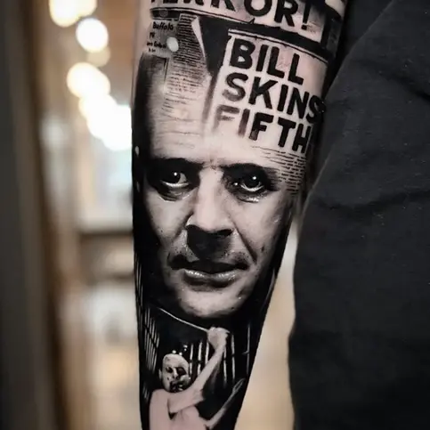 realistic black and grey hannibal lecter tattoo portrait on forearm