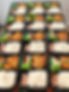 Multiple bento boxes arranged neatly, each containing a generous portion of crispy fried c