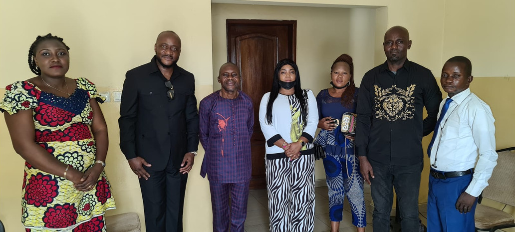 Group of Afro Innovation Group staff and local partners standing indoors for a partnership meeting in the DRC.