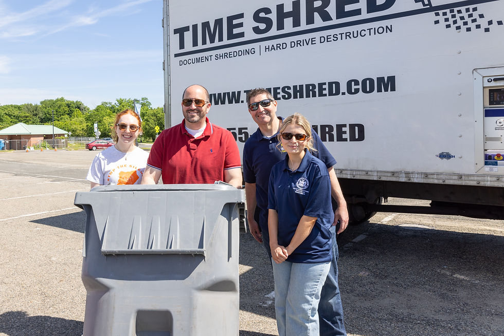 Mid-Island Councilman David Carr (red shirt) is joined by Staten Island SBDC Regional Director Michael Anderson and volunteers from the Office of Richmond County District Attorney Michael E. McMahon during a free paper shredding event at CSI.