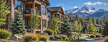 Colorado mountain residential community with maintained properties, landscaped grounds and snow-capped Rocky Mountain peaks