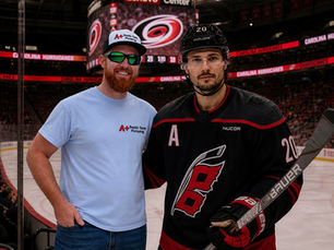 Joseph Sawvel of A+ Septic Tank Pumping and Sebastian Aho of the Carolina Hurricanes at the Lenovo Center in Raleigh, NC.