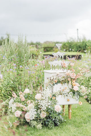 Best of both British flowers and dutch roses displayed on mini champagne tower Jacqui O Cheshire Florist. Photographer Sarah Horton 