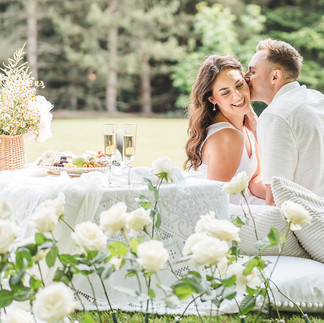 A loving couple enjoying a picnic surrounded by an arc of roses arranged by Jacqui Owen of Jacqui O