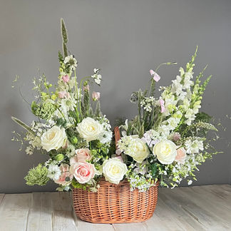 A shopping basket filled with pink and white flowers owned by a clients late mum to be displayed next to her photograph. The floral palette included gorgeous roses, delicate nigella and pretty ammi perfect for a garden lover. Created by Jacqui O of Nantwich Cheshire.