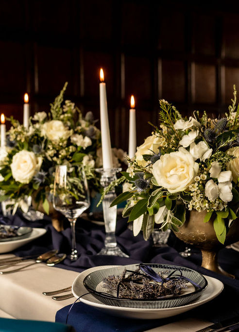 Private dinner party table flowers and styling with ‘Avalanche’ roses, scented dainty wax flower and ‘Solomio Ard’ dianthus and ‘Blue Lagoon’ eryngium nestled in scented eucalyptus