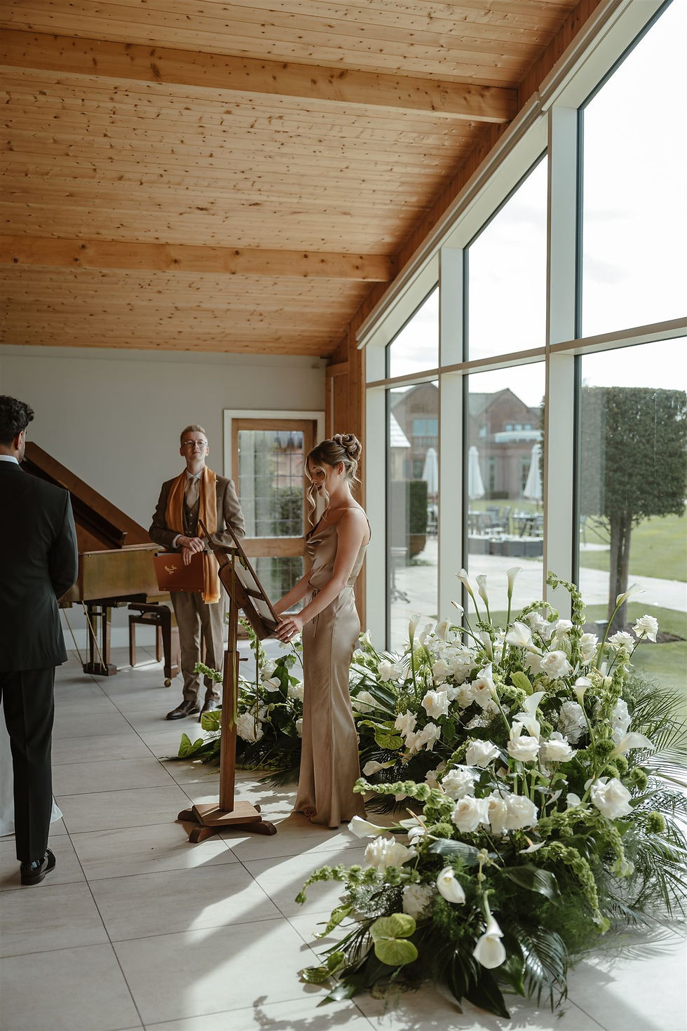 Sculptural white and green wedding floral installation in shape of a crescent